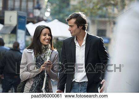 Couple walking and talking together outdoors View Large Photo Image Stock Image - Couple walking and talking together outdoors. Fotosearch