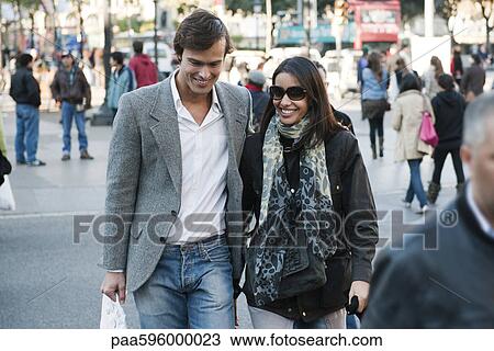 Couple walking on busy street View Large Photo Image Stock Image - Couple walking on busy street. Fotosearch