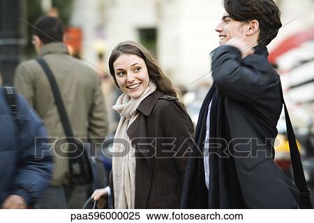 Couple walking on crowded street View Large Photo Image Stock Photography - Couple walking on crowded street. Fotosearch