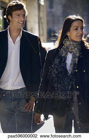 Couple walking together, backlit View Large Photo Image Stock Image - Couple walking together, backlit. Fotosearch