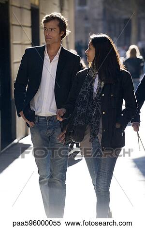 Stock Photography - Couple walking together, backlit. Fotosearch