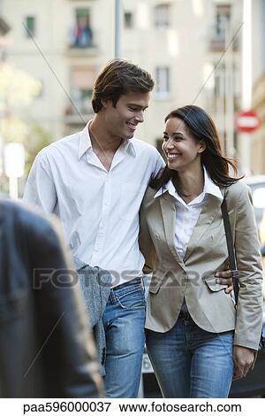 Stock Photo - Couple walking together outdoors. Fotosearch