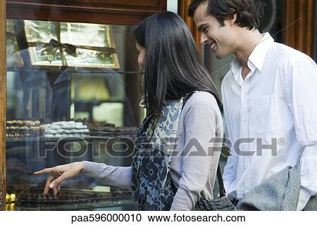 Couple window shopping View Large Photo Image Stock Image - Couple window shopping. Fotosearch