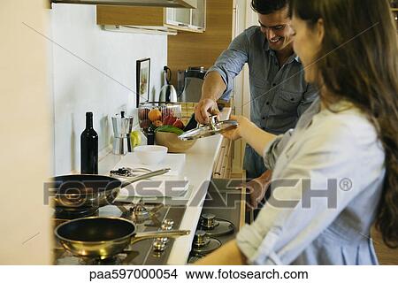 Couple cooking together View Large Photo Image Picture - Couple cooking together. Fotosearch