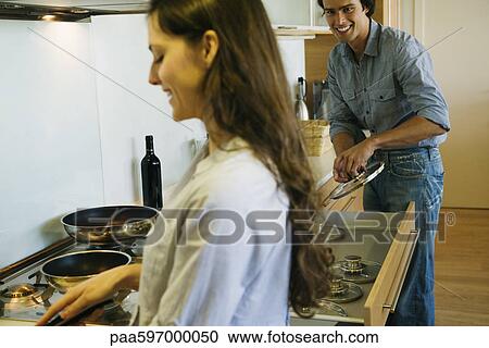 Couple cooking together View Large Photo Image Stock Image - Couple cooking together. Fotosearch