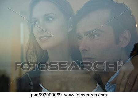 Couple looking through window, portrait View Large Photo Image Stock Photo - Couple looking through window, portrait. Fotosearch