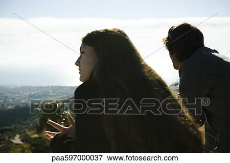 Couple on balcony, looking at view View Large Photo Image Stock Photo - Couple on balcony, looking at view. Fotosearch