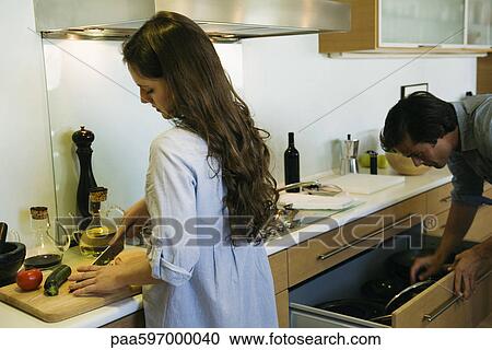 Couple preparing food together View Large Photo Image Stock Image - Couple preparing food together. Fotosearch