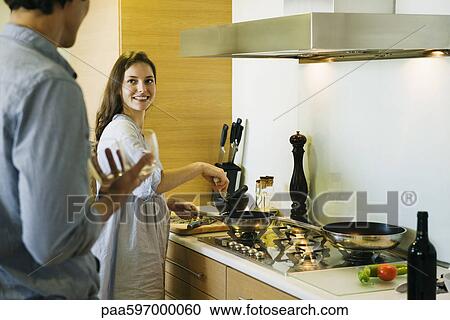 Couple preparing meal together View Large Photo Image Stock Image - Couple preparing meal together. Fotosearch