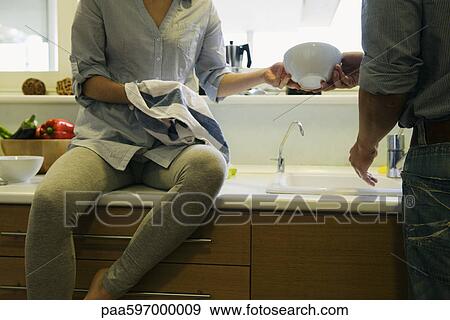 Couple washing dishes together View Large Photo Image Stock Photo - Couple washing dishes together. Fotosearch