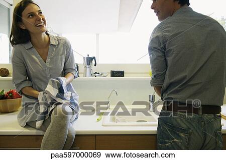 Couple washing dishes together View Large Photo Image Stock Photo - Couple washing dishes together. Fotosearch