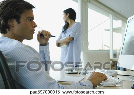 Man working on computer at home View Large Photo Image Stock Photography - Man working on computer at home. Fotosearch