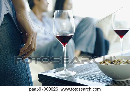 Stock Photograph - Red wine being served at party. Fotosearch