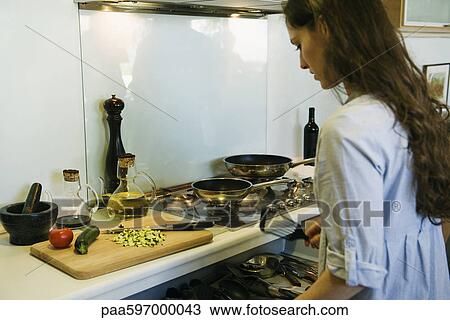Stock Image - Woman cooking. Fotosearch