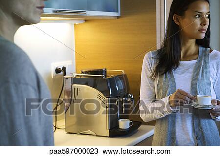 Woman enjoying cup of coffee in kitchen View Large Photo Image Stock Image - Woman enjoying cup of coffee in kitchen. Fotosearch