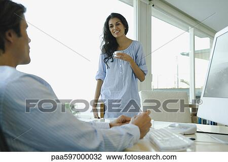 Woman enjoying cup of coffee, talking with husband View Large Photo Image Stock Image - Woman enjoying cup of coffee, talking with husband. Fotosearch