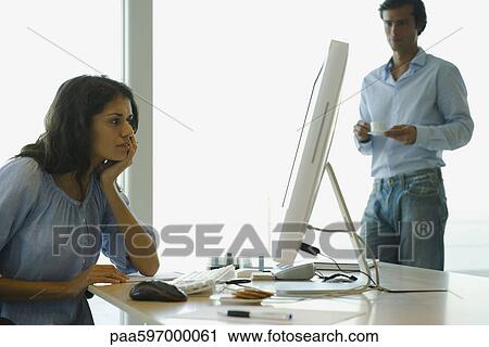 Woman working on computer at home, looking frustrated View Large Photo Image Stock Image - Woman working on computer at home, looking frustrated. Fotosearch