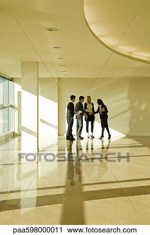 Stock Image - Business associates shaking hands. Fotosearch