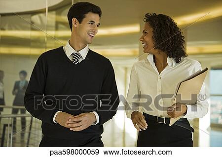 Business associates walking and talking together View Large Photo Image Stock Photo - Business associates walking and talking together. Fotosearch
