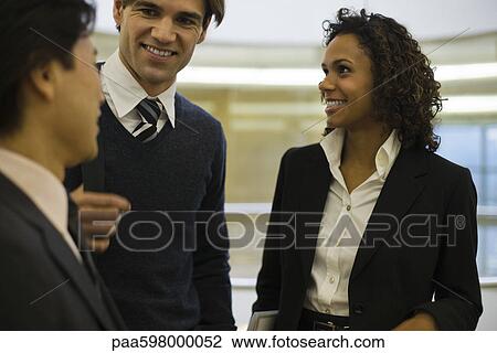 Colleagues chatting together View Large Photo Image Stock Image - Colleagues chatting together. Fotosearch