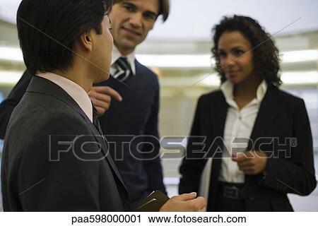 Executive talking to colleagues View Large Photo Image Stock Image - Executive talking to colleagues. Fotosearch