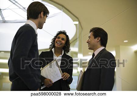 Executives chatting in corridor View Large Photo Image Stock Photo - Executives chatting in corridor. Fotosearch