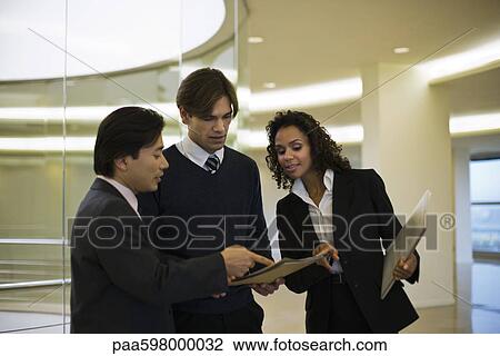 Executives discussing document View Large Photo Image Stock Image - Executives discussing document. Fotosearch