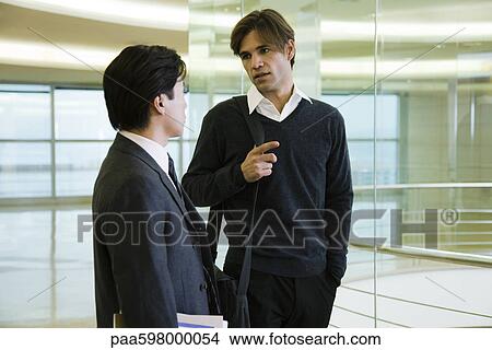 Executives talking in corridor View Large Photo Image Picture - Executives talking in corridor. Fotosearch