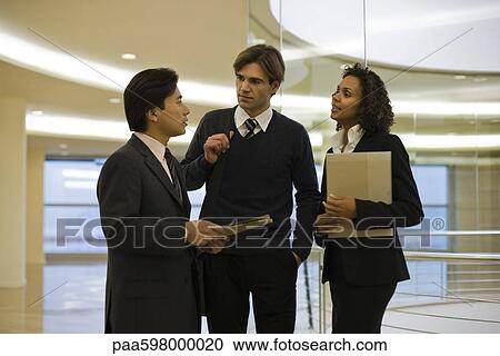 Executives talking in corridor View Large Photo Image Stock Image - Executives talking in corridor. Fotosearch