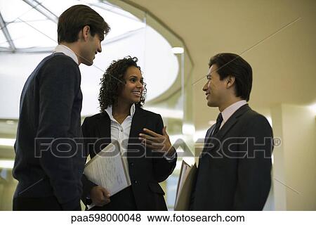 Executives talking in corridor View Large Photo Image Stock Photo - Executives talking in corridor. Fotosearch