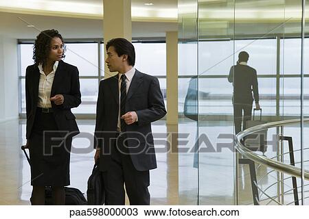 Executives walking and talking View Large Photo Image Stock Image - Executives walking and talking. Fotosearch
