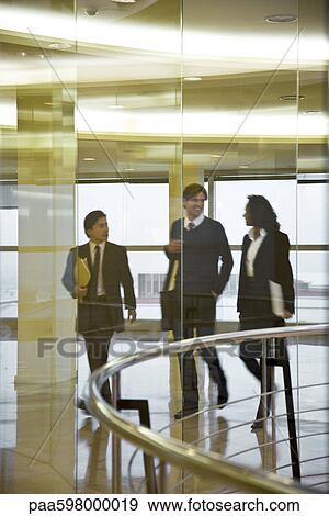 Executives walking and talking together View Large Photo Image Stock Photo - Executives walking and talking together. Fotosearch