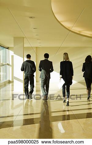 Executives walking in lobby, rear view View Large Photo Image Stock Photography - Executives walking in lobby, rear view. Fotosearch