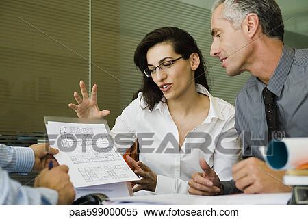 Business people discussing blueprint View Large Photo Image Stock Photography - Business people discussing blueprint. Fotosearch