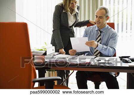 Businessman talking to colleague View Large Photo Image Stock Image - Businessman talking to colleague. Fotosearch