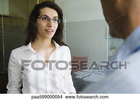 Businesswoman discussing work with colleague View Large Photo Image Picture - Businesswoman discussing work with colleague. Fotosearch
