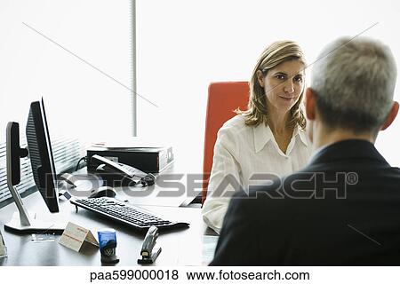 Businesswoman meeting with client in office View Large Photo Image Stock Photo - Businesswoman meeting with client in office. Fotosearch