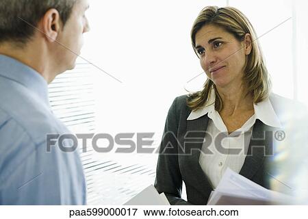 Businesswoman talking to colleague View Large Photo Image Stock Photo - Businesswoman talking to colleague. Fotosearch