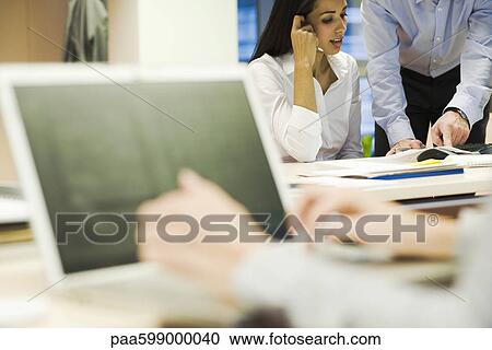 Colleagues discussing work in office View Large Photo Image Stock Image - Colleagues discussing work in office. Fotosearch