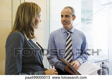 Colleagues talking in office View Large Photo Image Stock Image - Colleagues talking in office. Fotosearch
