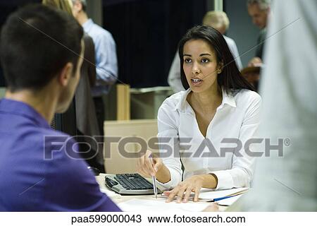 Colleagues working together in office at night View Large Photo Image Stock Image - Colleagues working together in office at night. Fotosearch