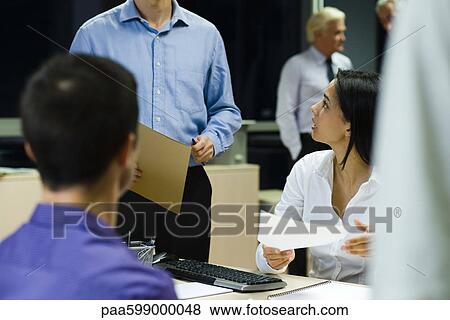 Colleagues working together in office at night View Large Photo Image Stock Photo - Colleagues working together in office at night. Fotosearch
