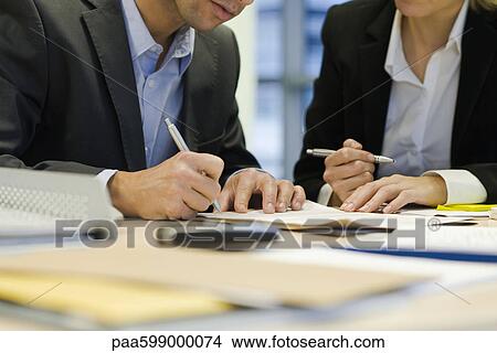 Executive signing paperwork, cropped View Large Photo Image Picture - Executive signing paperwork, cropped. Fotosearch