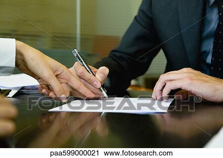 Stock Image - Executive signing paperwork. Fotosearch