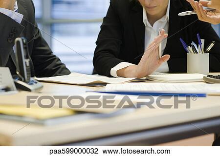 Stock Image - Executives in meeting, cropped. Fotosearch
