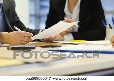 Stock Photo - Executives in meeting, cropped. Fotosearch
