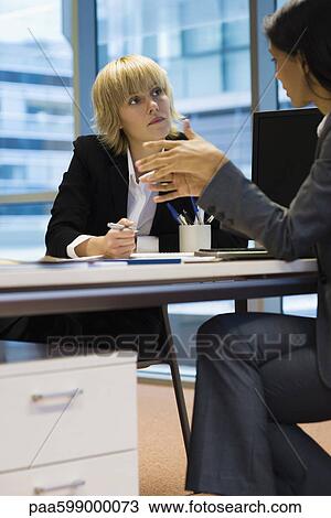 Stock Image - Executives in meeting. Fotosearch