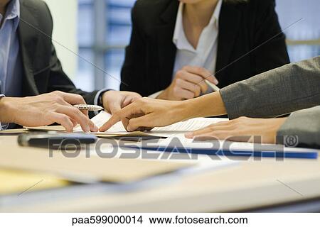 Picture - Executives negotiating in meeting, cropped. Fotosearch