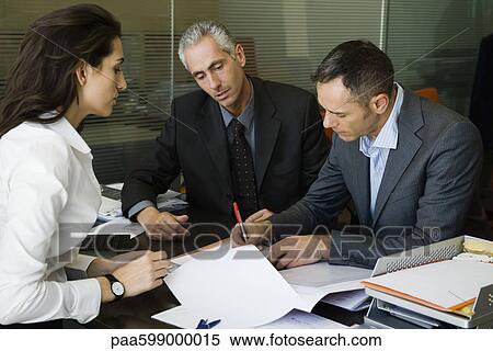 Executives signing paperwork in office View Large Photo Image Stock Photography - Executives signing paperwork in office. Fotosearch