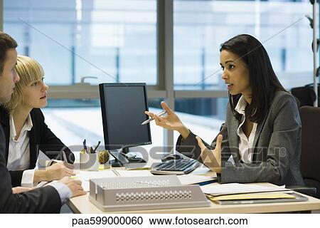 Female executive talking to colleagues View Large Photo Image Stock Image - Female executive talking to colleagues. Fotosearch